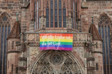 German-church-with-Pride-flag-scaled-810x500.jpg