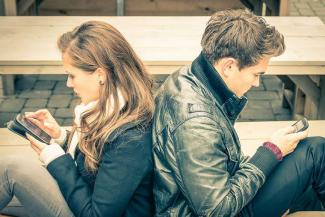 Couple_looking_at_phones_Credit_View_Apart_Shutterstock_CNA.jpg