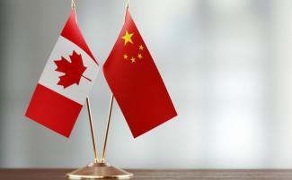 China-flag-canada-flag-810x500.jpeg