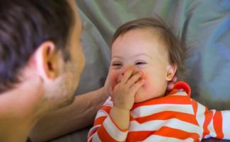happy-baby-with-down-syndrome-810x500.jpg