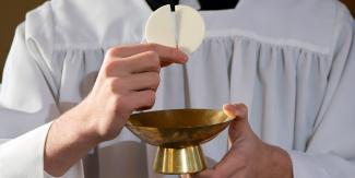 web3-priest-eucharist-host-shutterstock_241121287.jpg